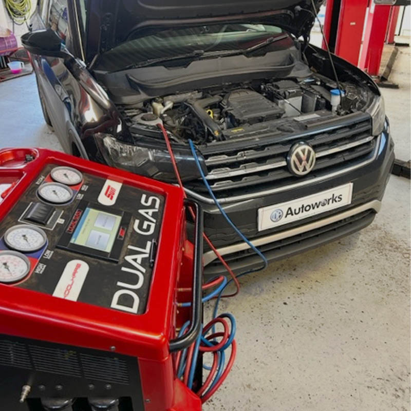 Dual Gas vehicle air conditioning service unit performing maintenance on a car at DP Autoworks